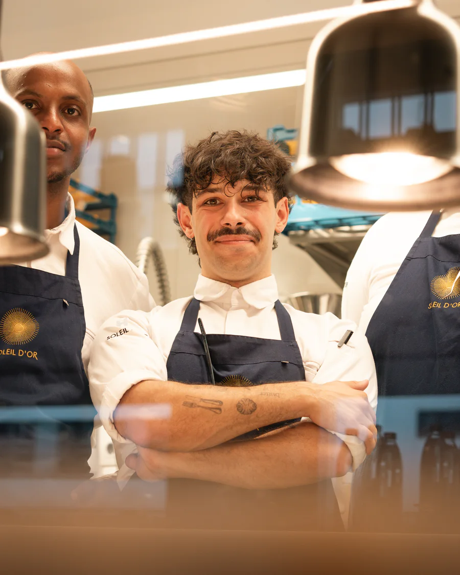 Two chefs at Soleil d'Or in the pass, arms folded.